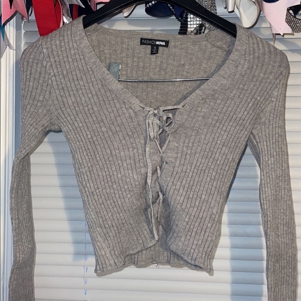 gray sweater material shirt, adjustable stings in the front, stretchy